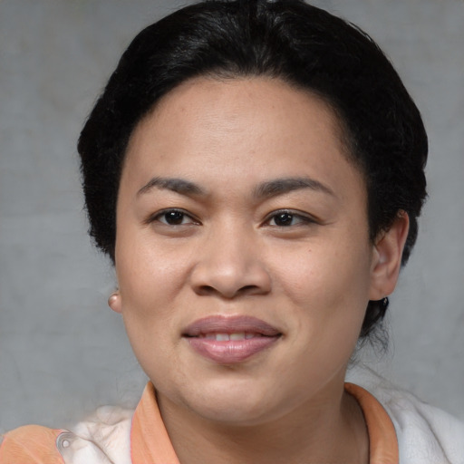 Joyful asian young-adult female with short  black hair and brown eyes