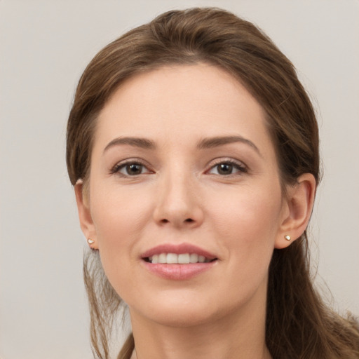 Joyful white young-adult female with long  brown hair and grey eyes