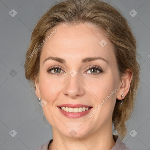 Joyful white young-adult female with medium  brown hair and grey eyes