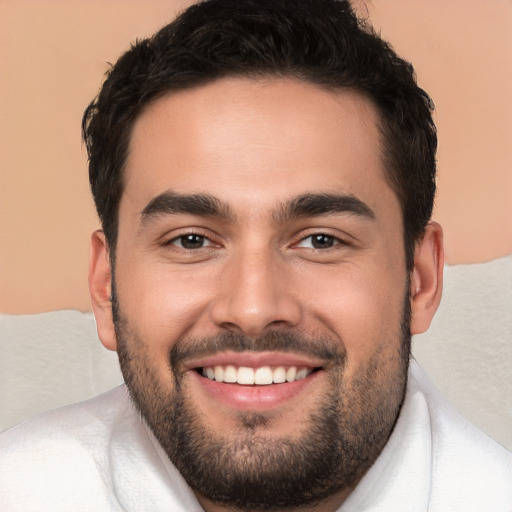 Joyful white young-adult male with short  black hair and brown eyes