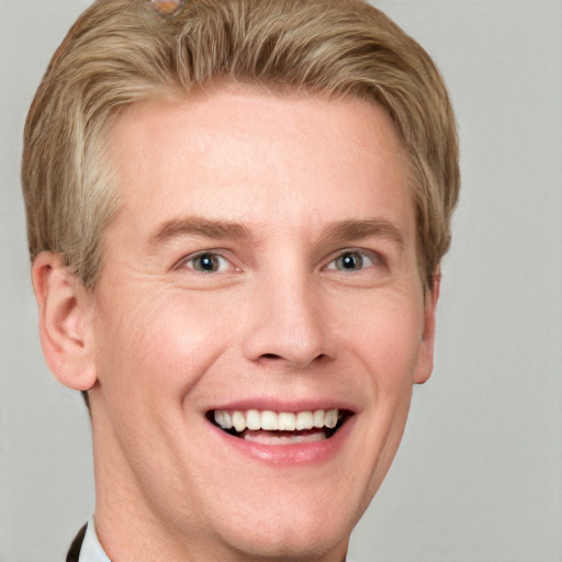 Joyful white adult male with short  brown hair and blue eyes