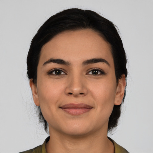 Joyful latino young-adult female with medium  black hair and brown eyes