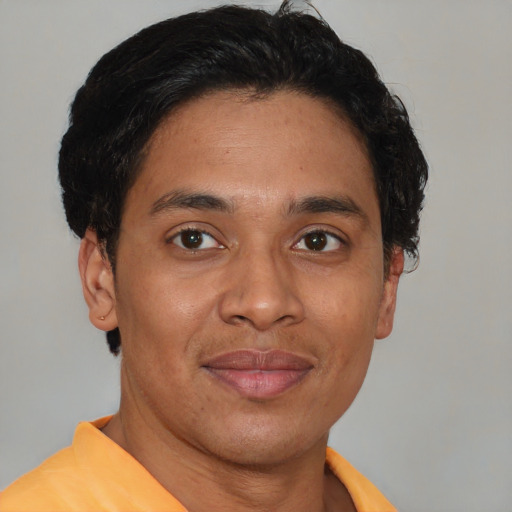 Joyful latino young-adult male with short  brown hair and brown eyes