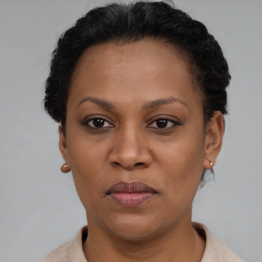 Joyful black adult female with short  brown hair and brown eyes