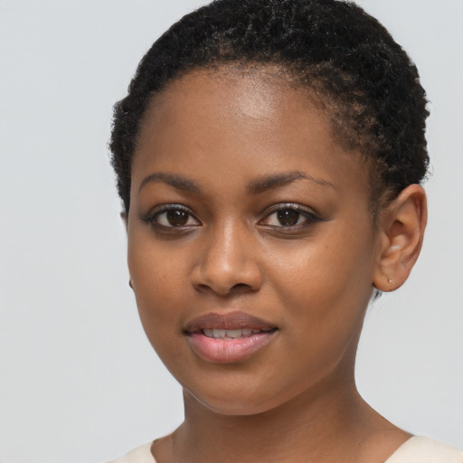 Joyful black young-adult female with short  brown hair and brown eyes