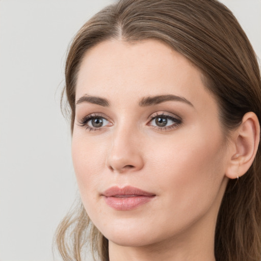 Joyful white young-adult female with long  brown hair and grey eyes