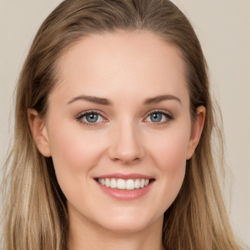 Joyful white young-adult female with long  brown hair and grey eyes