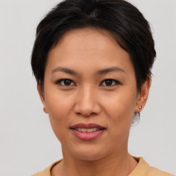 Joyful asian young-adult female with short  brown hair and brown eyes