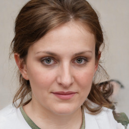 Joyful white young-adult female with medium  brown hair and blue eyes