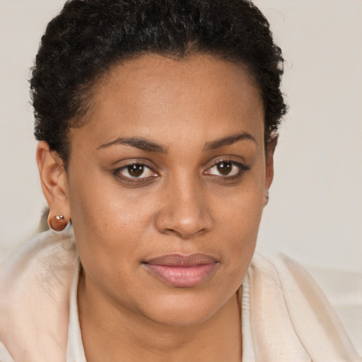 Joyful black young-adult female with short  brown hair and brown eyes