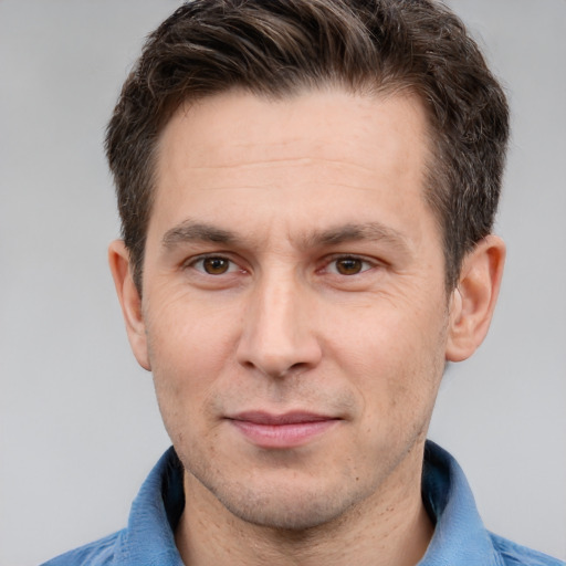 Joyful white adult male with short  brown hair and brown eyes