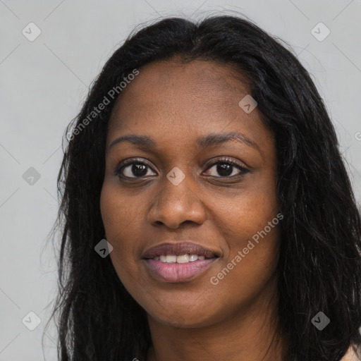 Joyful black young-adult female with long  black hair and brown eyes