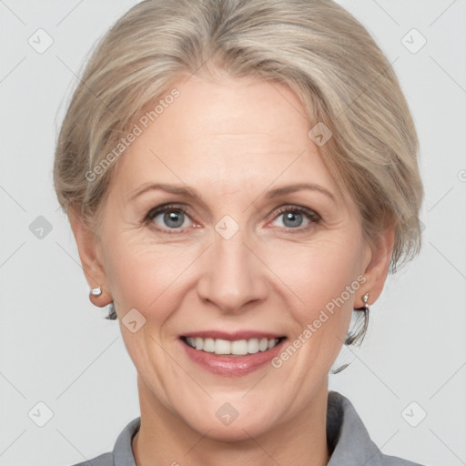 Joyful white adult female with medium  brown hair and grey eyes