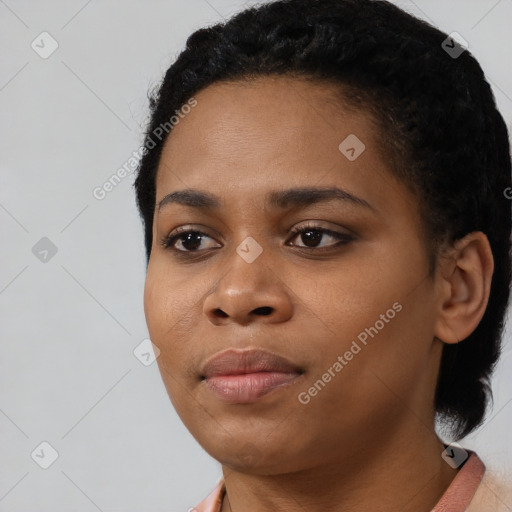 Joyful black young-adult female with short  black hair and brown eyes