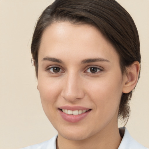 Joyful white young-adult female with medium  brown hair and brown eyes