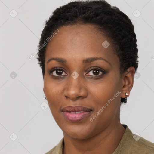 Joyful black adult female with short  brown hair and brown eyes