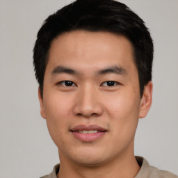 Joyful asian young-adult male with short  black hair and brown eyes