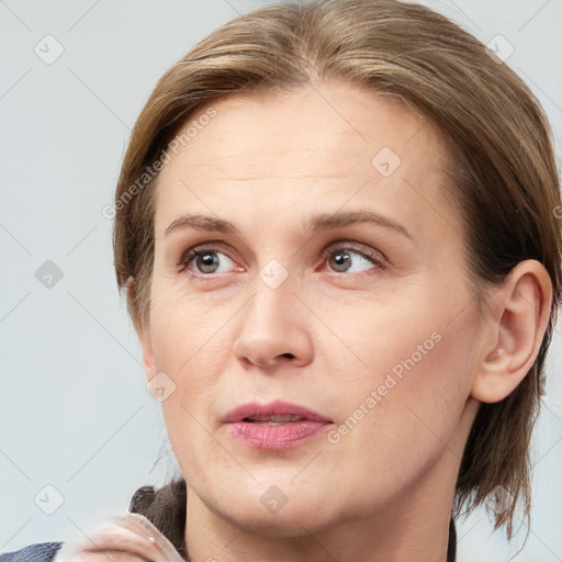 Joyful white adult female with medium  brown hair and grey eyes