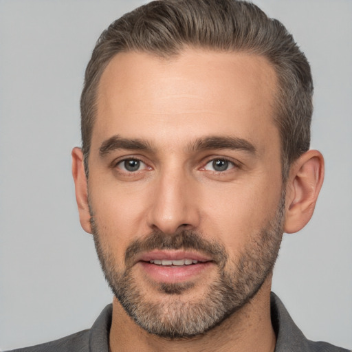 Joyful white adult male with short  brown hair and brown eyes