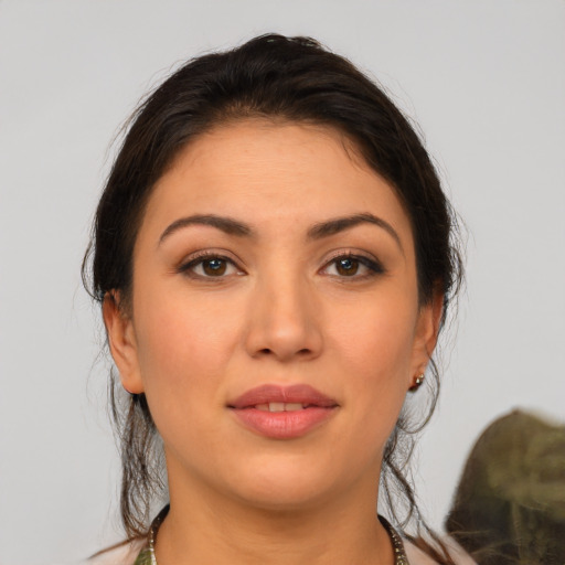 Joyful latino young-adult female with medium  brown hair and brown eyes
