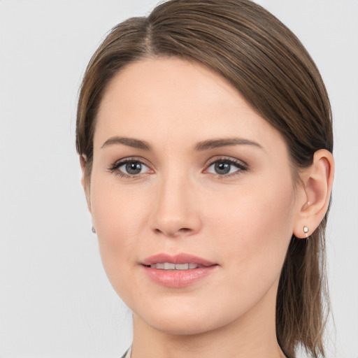 Joyful white young-adult female with long  brown hair and grey eyes