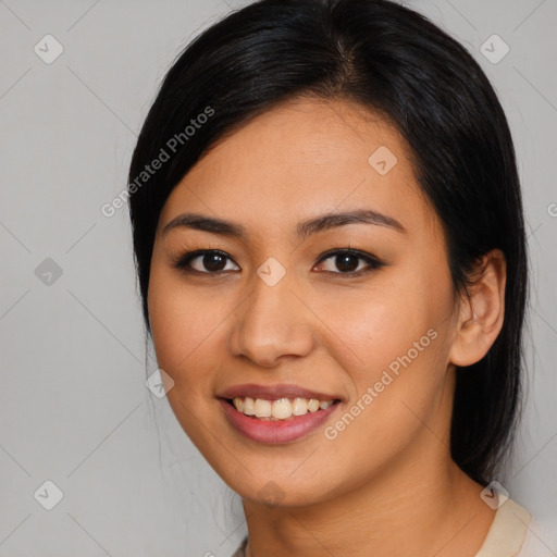 Joyful asian young-adult female with medium  black hair and brown eyes