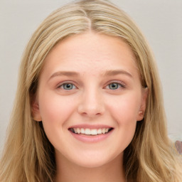 Joyful white young-adult female with long  brown hair and blue eyes