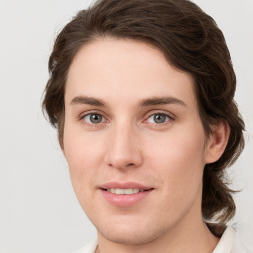 Joyful white young-adult female with medium  brown hair and green eyes