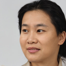 Joyful asian adult female with medium  brown hair and brown eyes