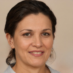 Joyful white adult female with medium  brown hair and brown eyes