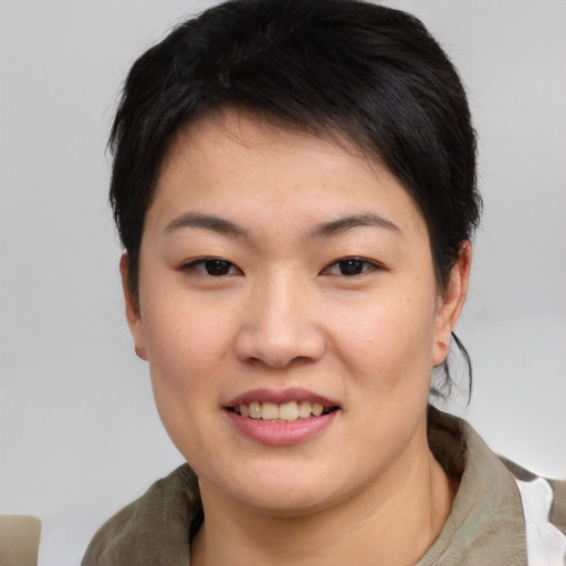 Joyful asian young-adult female with short  black hair and brown eyes