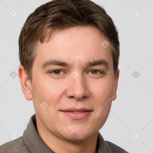 Joyful white young-adult male with short  brown hair and grey eyes