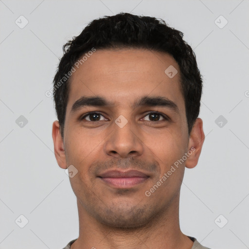 Joyful latino young-adult male with short  black hair and brown eyes