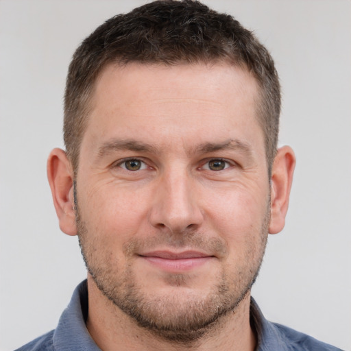 Joyful white adult male with short  brown hair and brown eyes