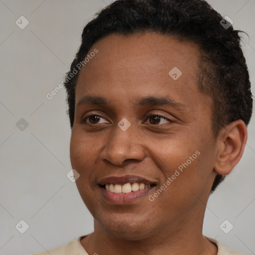 Joyful black young-adult male with short  brown hair and brown eyes