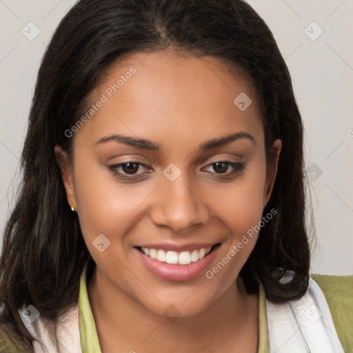 Joyful latino young-adult female with long  brown hair and brown eyes