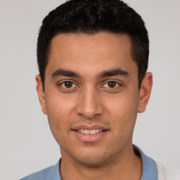 Joyful white young-adult male with short  black hair and brown eyes