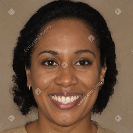 Joyful black adult female with long  brown hair and brown eyes