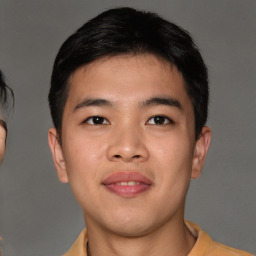 Joyful asian young-adult male with short  brown hair and brown eyes
