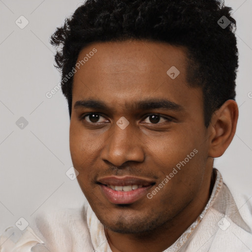 Joyful black young-adult male with short  black hair and brown eyes