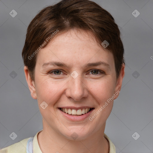 Joyful white young-adult female with short  brown hair and grey eyes