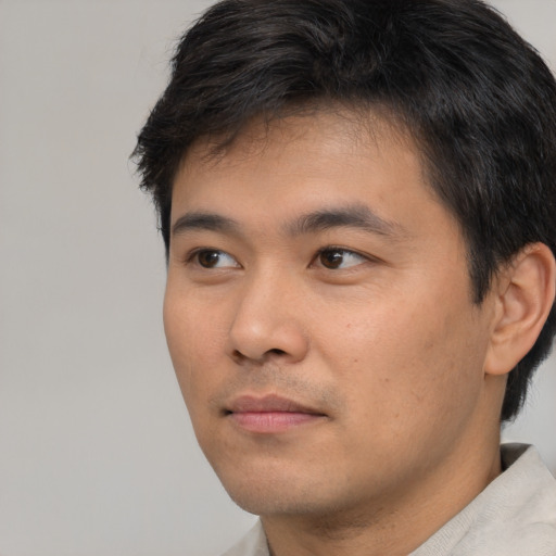 Neutral asian young-adult male with short  black hair and brown eyes