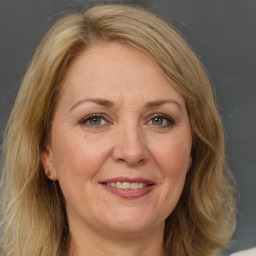 Joyful white adult female with long  brown hair and brown eyes