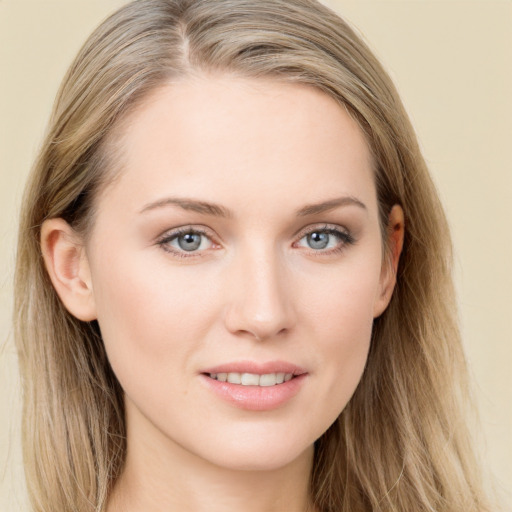 Joyful white young-adult female with long  brown hair and blue eyes