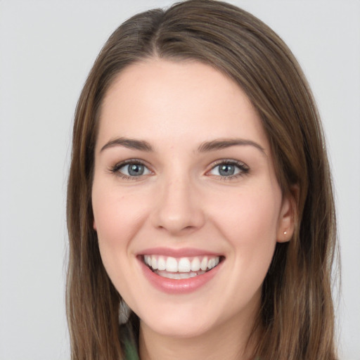 Joyful white young-adult female with long  brown hair and grey eyes