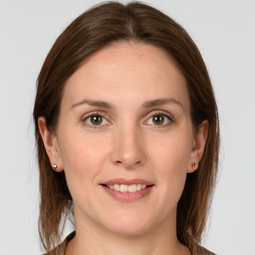 Joyful white young-adult female with long  brown hair and grey eyes