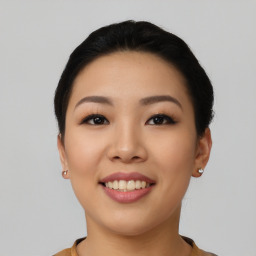 Joyful asian young-adult female with short  black hair and brown eyes