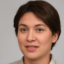 Joyful white young-adult female with medium  brown hair and brown eyes