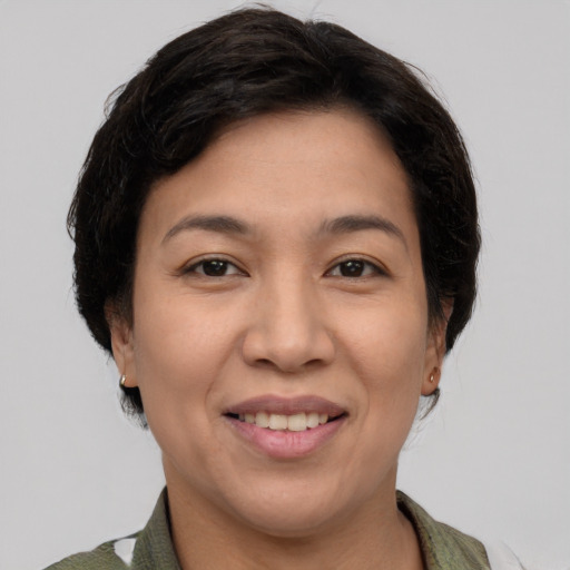 Joyful asian young-adult female with short  brown hair and brown eyes