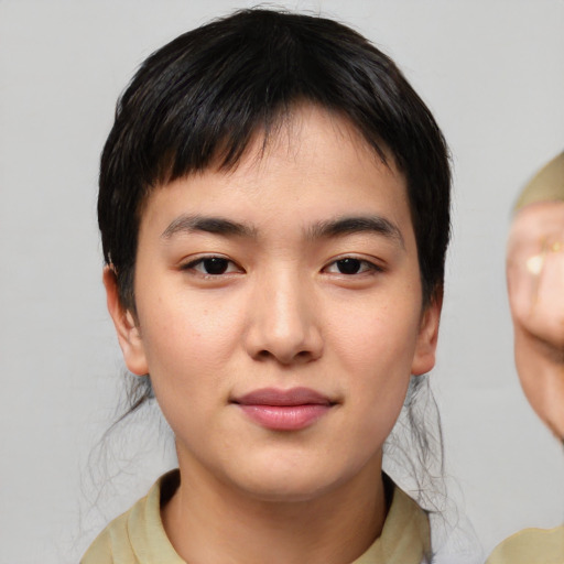 Joyful asian young-adult male with medium  black hair and brown eyes